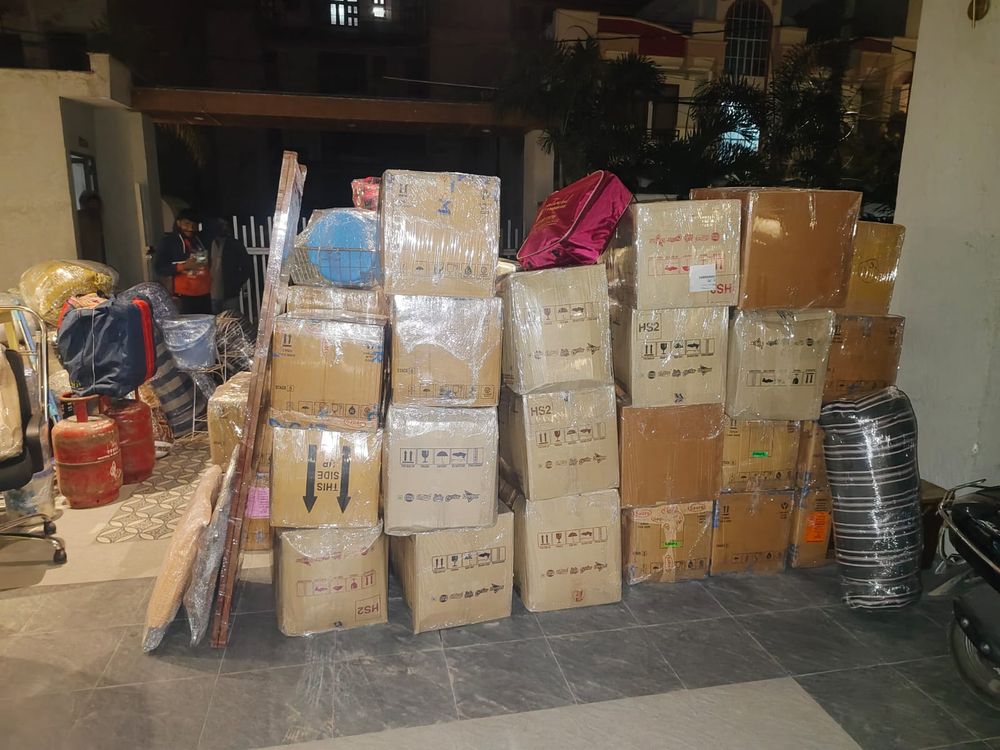 Packed boxes stacked and staged in a garage